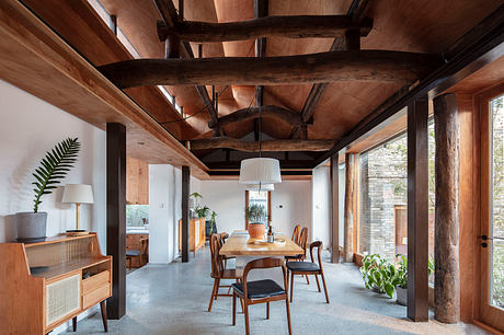 Rustic wooden beams, concrete floors, and natural light create a warm, inviting space.