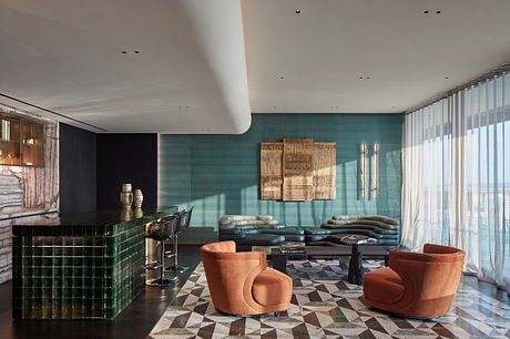 Stunning modern lounge with geometric flooring, glass walls, and plush seating.