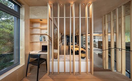 A modern, wooden-framed interior with shelving, a desk, and a minimalist design aesthetic.