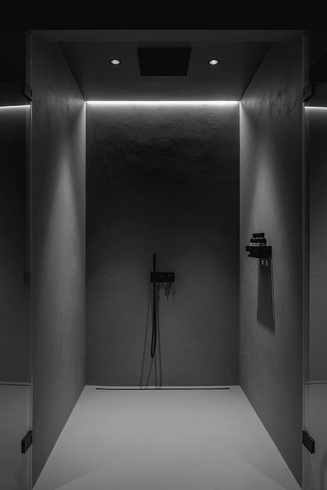 A minimalist bathroom design with a sleek, modern shower area and recessed lighting.