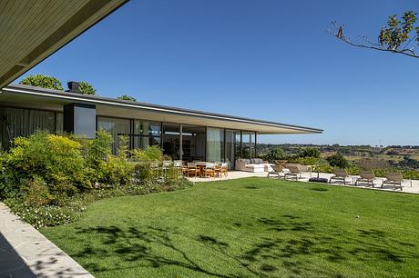 Casa Fluir is a L-Shaped House Designed Around a Shared Central Courtyard - 1