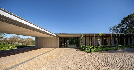Casa Fluir is a L-Shaped House Designed Around a Shared Central Courtyard - 8