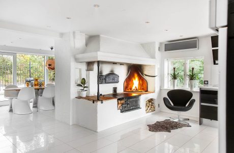 Spacious modern living area with a cozy fireplace and natural wood accents.