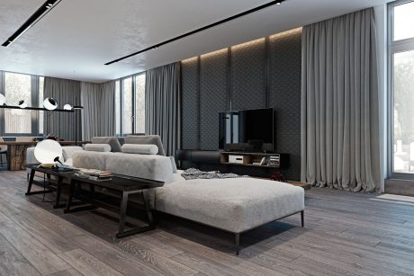 Minimalist living room with gray textured walls, plush sofas, and wooden flooring.