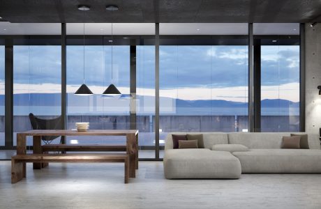 Expansive floor-to-ceiling windows frame sweeping mountain views in this contemporary, minimalist space.