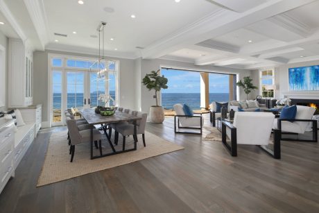 Spacious living room with expansive ocean views, modern coastal design, and elegant furnishings.