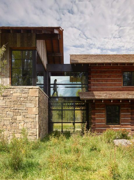 Rustic modern architecture with mix of stone, wood, and glass elements.