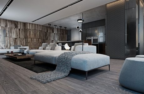 Sleek, modern living room with gray sectional, shag rug, and textured feature wall.