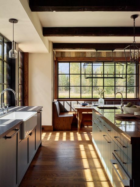 Rustic kitchen with wood beams, large windows, and contemporary fixtures.