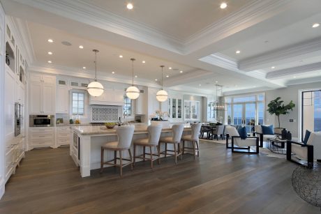 Spacious open-concept kitchen and living room with elegant architectural features.