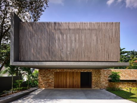 A modern architectural design featuring a concrete cantilevered roof and stone facade.