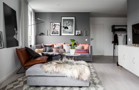 Cozy living room with plush gray sectional, patterned throw pillows, and framed artwork.
