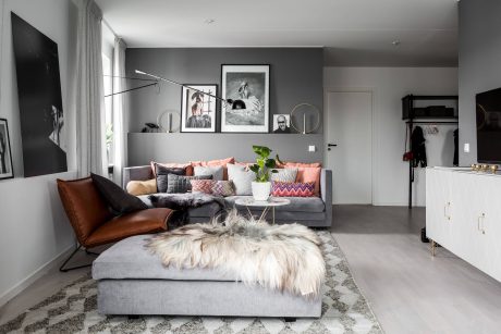 Cozy living room with plush gray sectional, patterned throw pillows, and framed artwork.