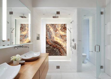 Spacious modern bathroom with marble walk-in shower, floating vanity, and unique wall tiles.