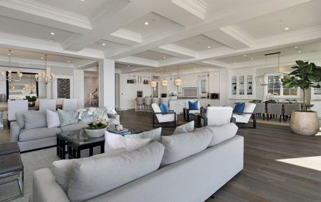 Spacious open-concept living area with high ceilings, cozy seating arrangements, and modern decor.