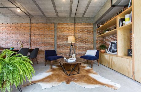 Rustic concrete and brick interior with modern furnishings and decor.