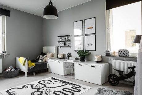 Well-designed modern room with gray walls, minimalist furnishings, and artistic decor accents.