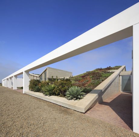 Striking modern architecture with geometric shapes, terraced gardens, and natural materials.