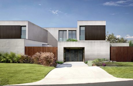 Modern minimalist residential building with clean lines, wood paneling, and manicured landscaping.