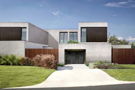 Modern minimalist residential building with clean lines, wood paneling, and manicured landscaping.