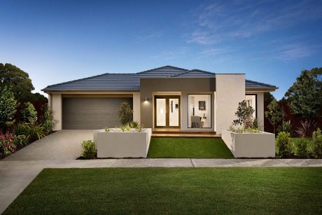 Modern single-story house with sleek architecture, large windows, and lush landscaping.