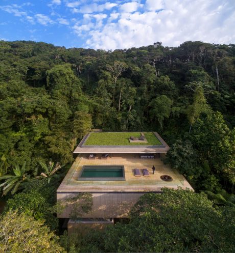 Stunning modern eco-lodge design nestled in lush tropical forest canopy.