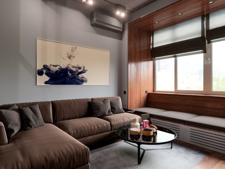 Cozy living room with plush leather sofa, framed artwork, and wooden paneling accents.