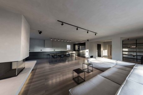 Spacious, modern interior with clean lines, track lighting, and minimalist furniture.