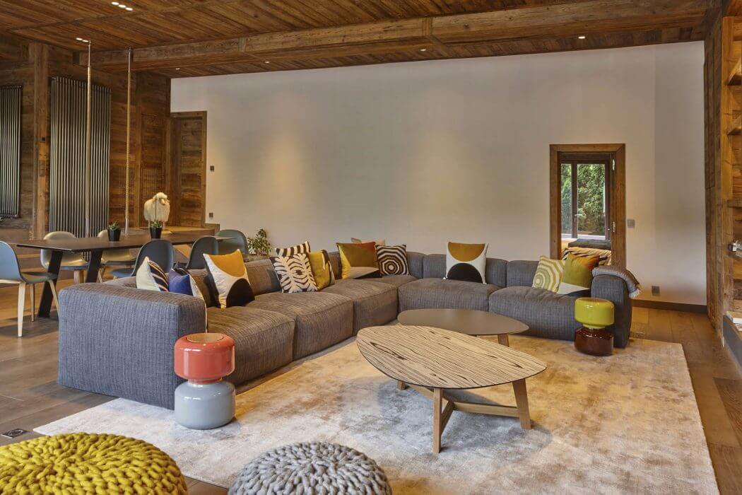 Warm, rustic wooden interior with modern, cozy furnishings and decor elements.