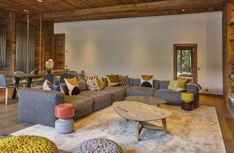 Warm, rustic wooden interior with modern, cozy furnishings and decor elements.