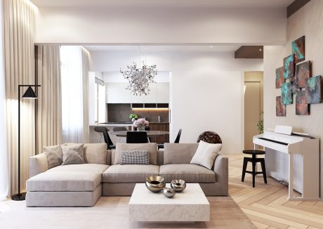 Spacious, modern living room with sleek furniture, custom artwork, and a striking crystal chandelier.