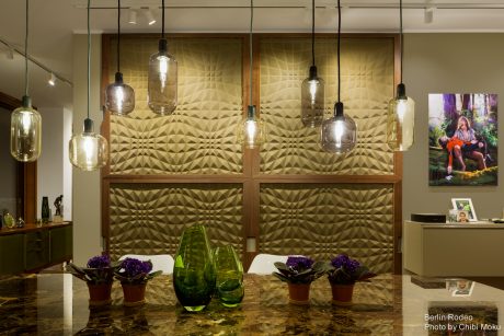 Striking geometric-patterned wall panels and pendant lights in a modern interior.