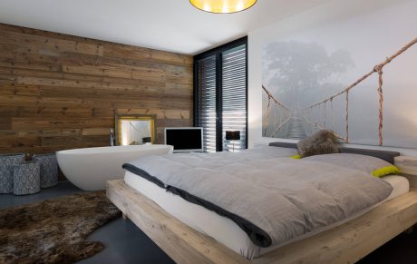 Rustic wooden walls, plush bedding, and a suspended rope bridge create a cozy, modern retreat.
