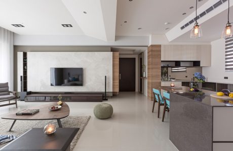 Modern, open-plan living space with sleek kitchen, dining, and lounge areas.