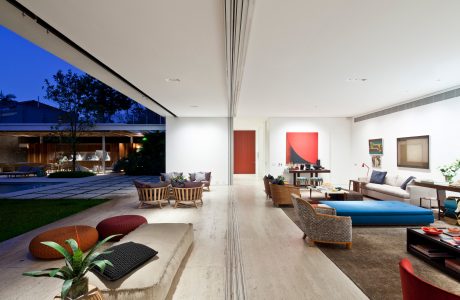 Expansive open-plan living space with sliding glass walls that connect to the outdoor area.