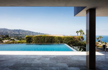 Sleek contemporary architecture, infinity pool, and scenic coastal view.