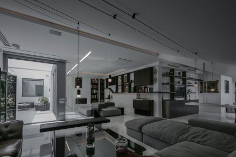 Sleek, modern interior design with minimalist furniture, recessed lighting, and built-in shelving.