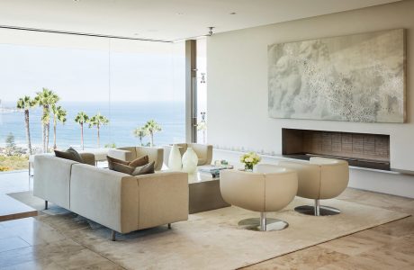 Expansive living space with neutral tones, floor-to-ceiling windows, and modern furnishings.