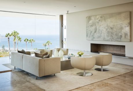 Expansive living space with neutral tones, floor-to-ceiling windows, and modern furnishings.