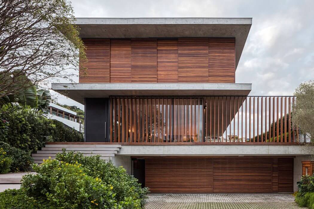Modern wooden facade with elevated balcony and distinct architectural features.
