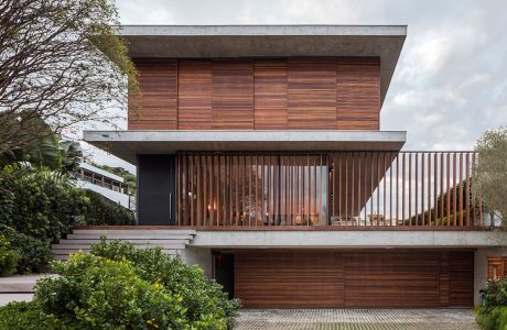 Modern wooden facade with elevated balcony and distinct architectural features.