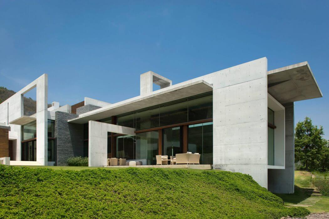 Striking modern architecture with clean lines, large glass walls, and lush landscaping.