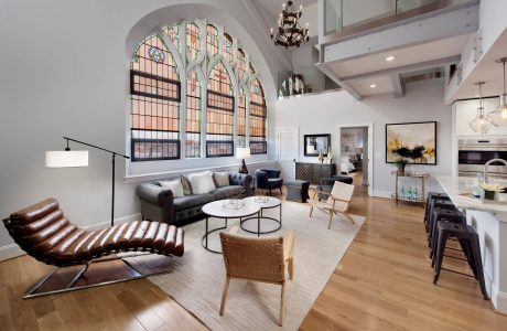 Elegant living space with ornate arched windows, contemporary furnishings, and warm lighting.