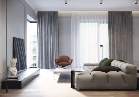 Contemporary living room with tall windows, plush sofa, leather chair, and minimalist decor.