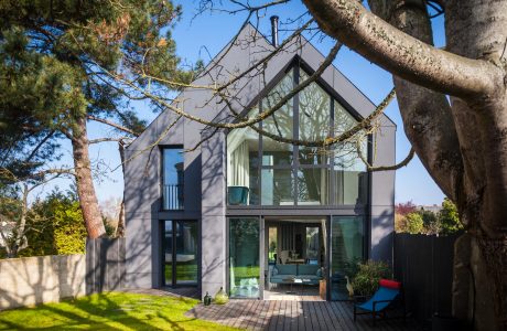 Striking modern home with expansive glass walls and a spacious, open interior.