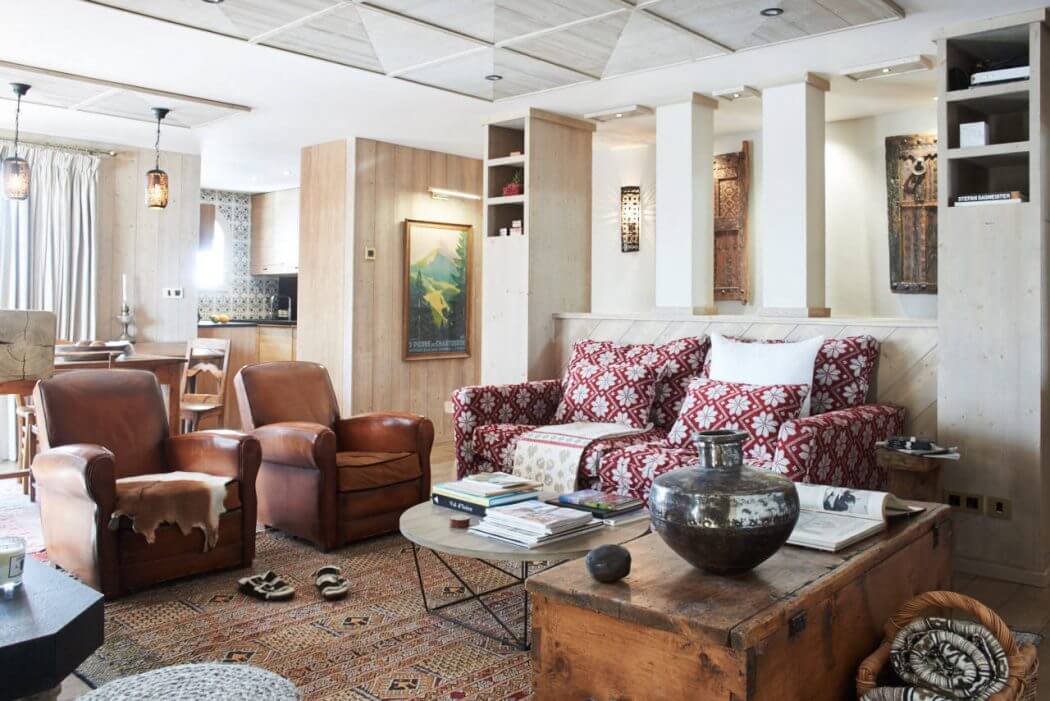 A cozy, rustic living room with wooden furniture, patterned fabrics, and decorative accents.