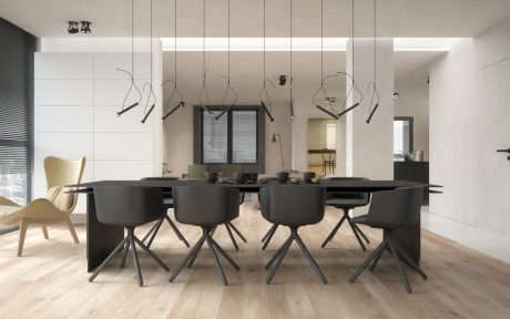 Large, minimalist dining room with black chairs, table, and modern light fixtures.