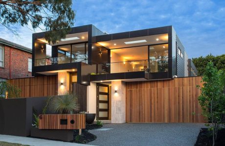 Sleek, modern home with glass walls, wooden accents, and a stunning exterior design.