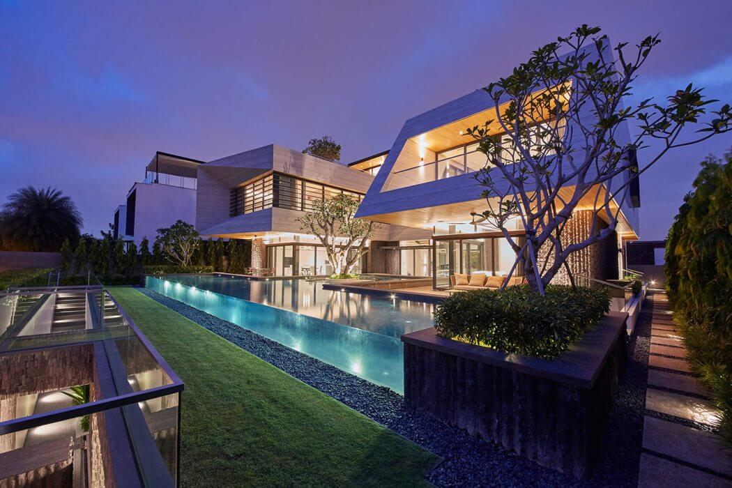 Modern architectural masterpiece with stunning pool, landscaping, and lighting.