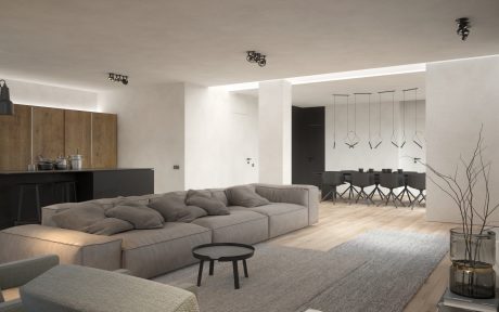 Minimalist open-plan living space with neutral tones, modern furniture, and statement lighting.